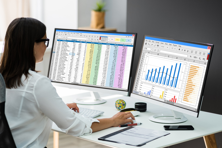 The image above illustrates a professional engaged with data analysis on a spreadsheet, symbolizing the transition from chaotic email inboxes to organized, actionable insights via emails to sheets.